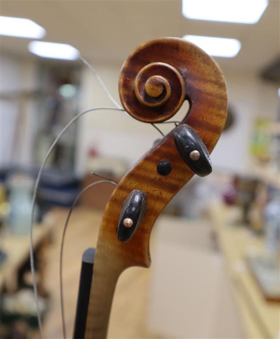 An early 20th century violin, bears label Paolo Fiorini, Taurini 1928, cased with a bow, single-piece back 36cm